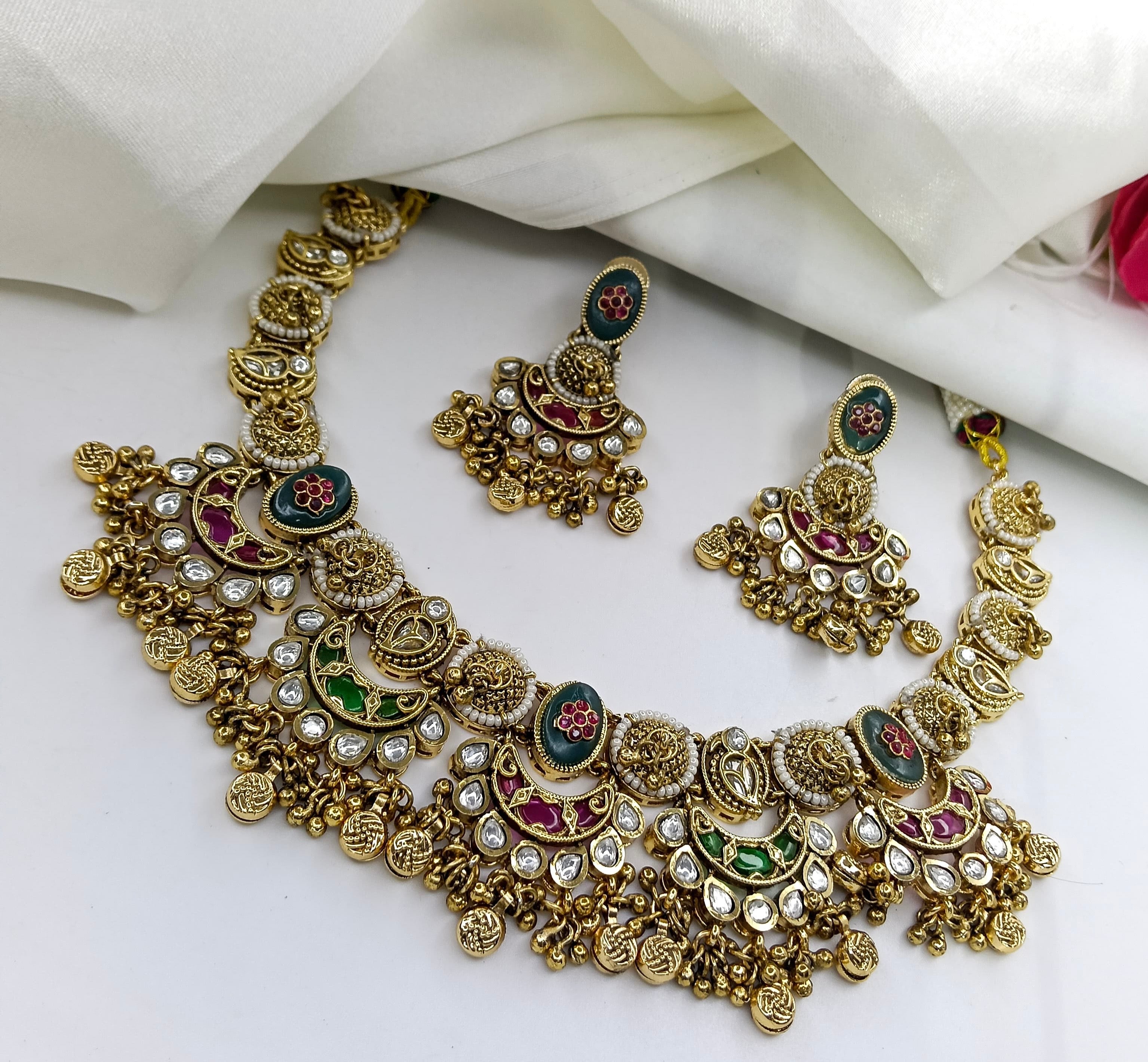 This is a heritage-style gold-plated necklace set with matching earrings, featuring kempu and hydra beads and a matte gold finish.