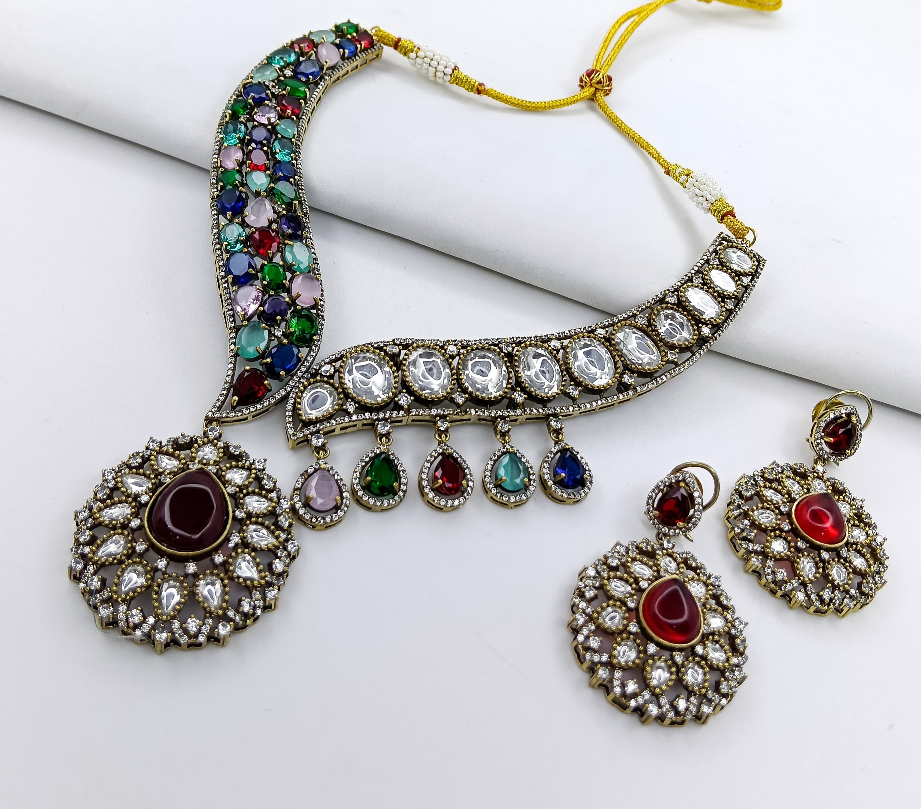 This is a Victorian-style Kundan necklace set with multicolored stones.