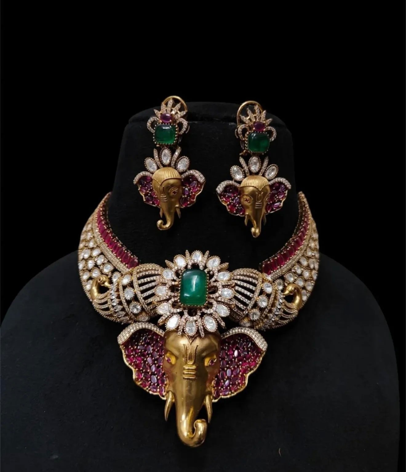 This is a traditional Indian choker necklace featuring a Ganesha pendant, studded with rubies, emeralds, and diamonds.