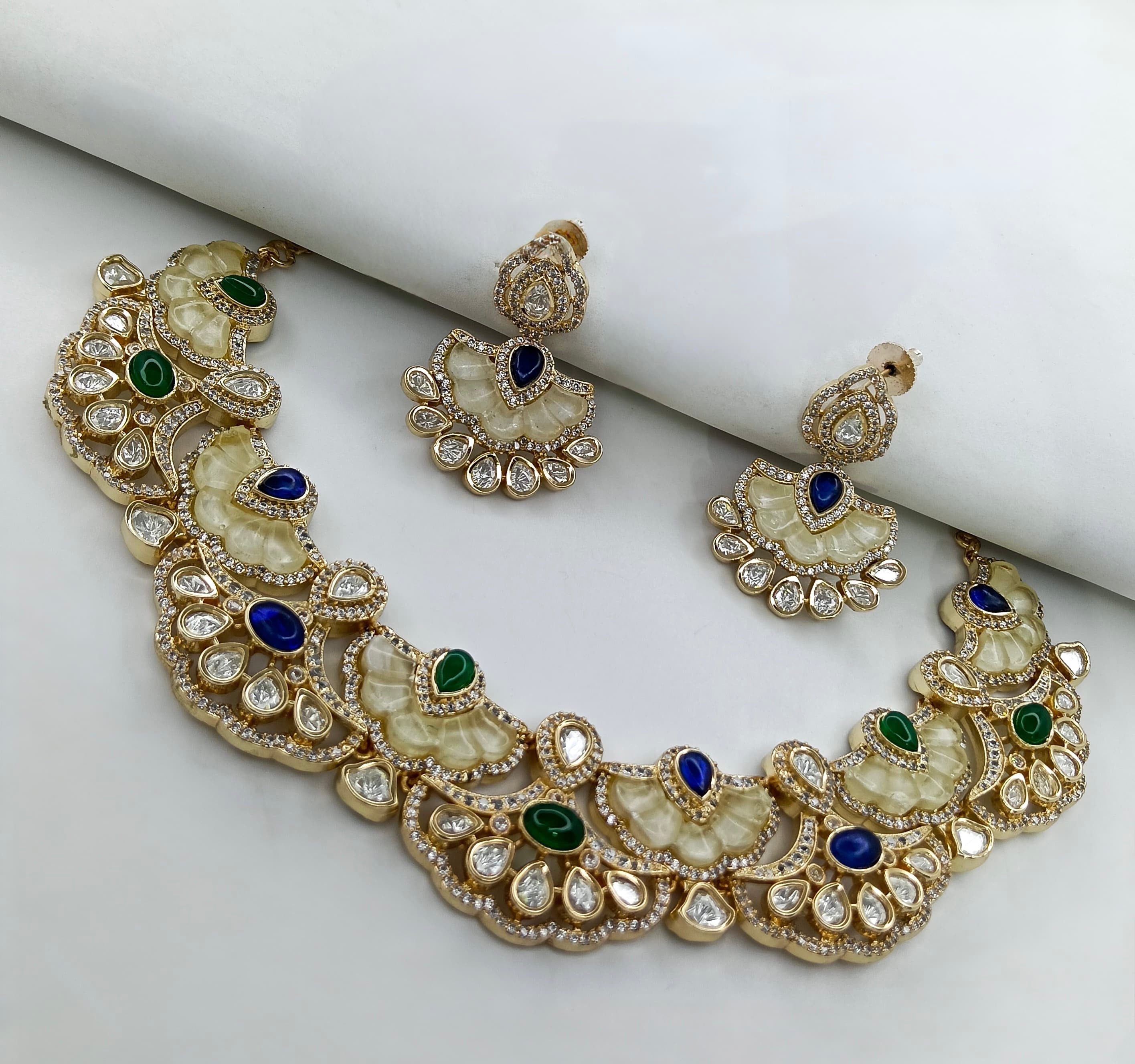 This is a Polki Meenakari necklace set, which includes a choker necklace and matching earrings.