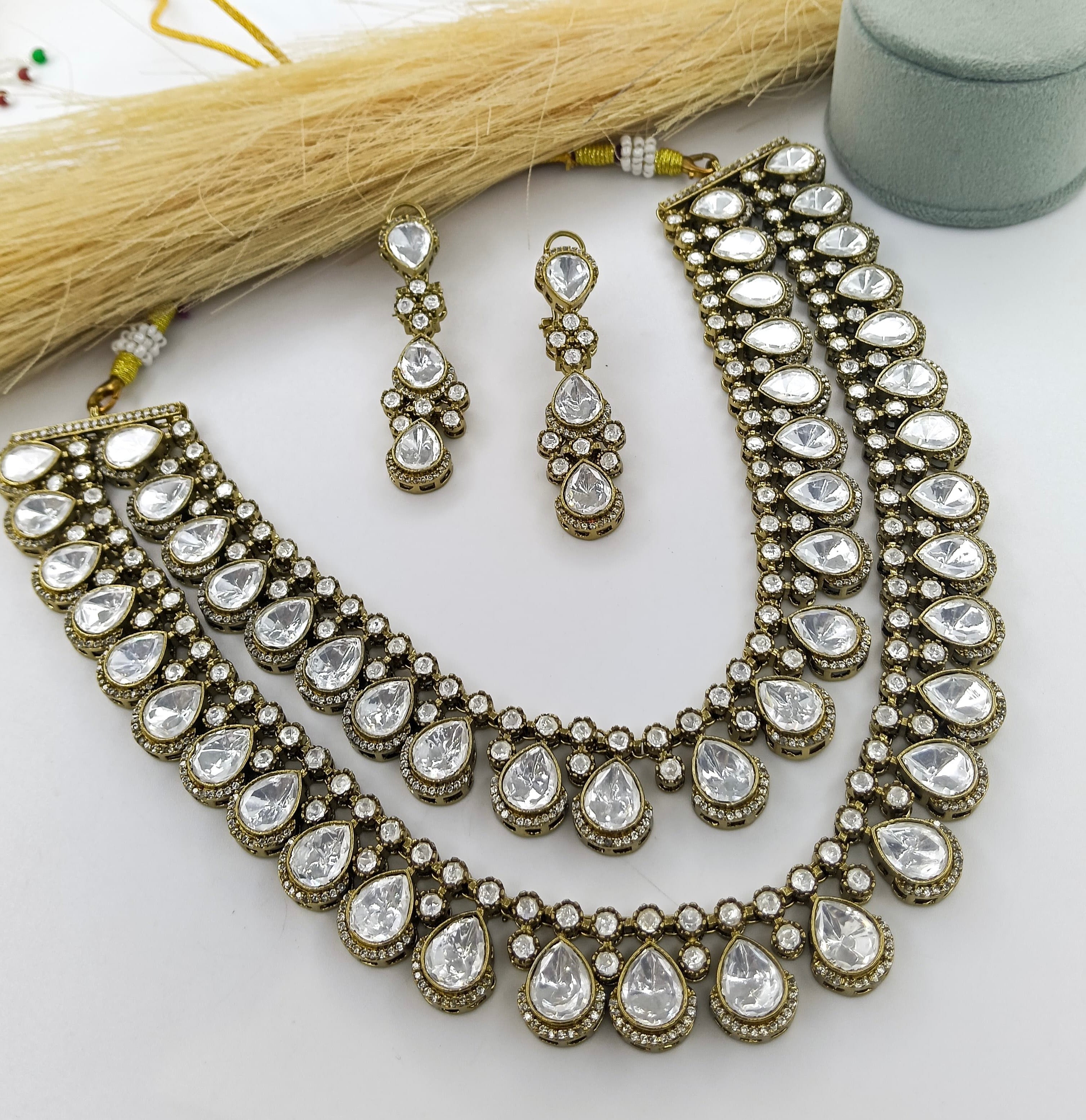 This is a Kundan necklace set, a traditional form of Indian gemstone jewelry.