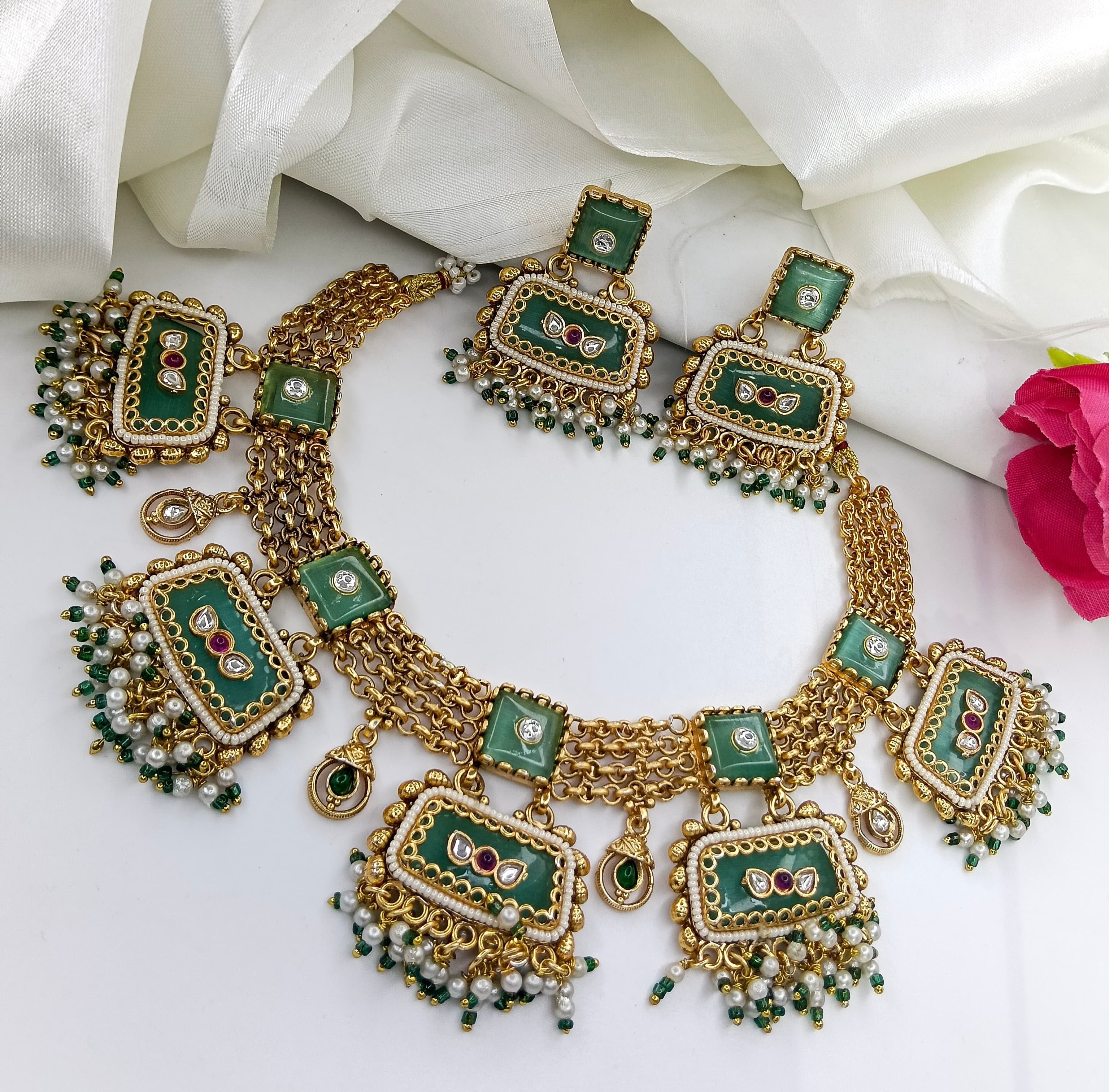This is a gold-plated Kundan Meenakari bridal necklace set.