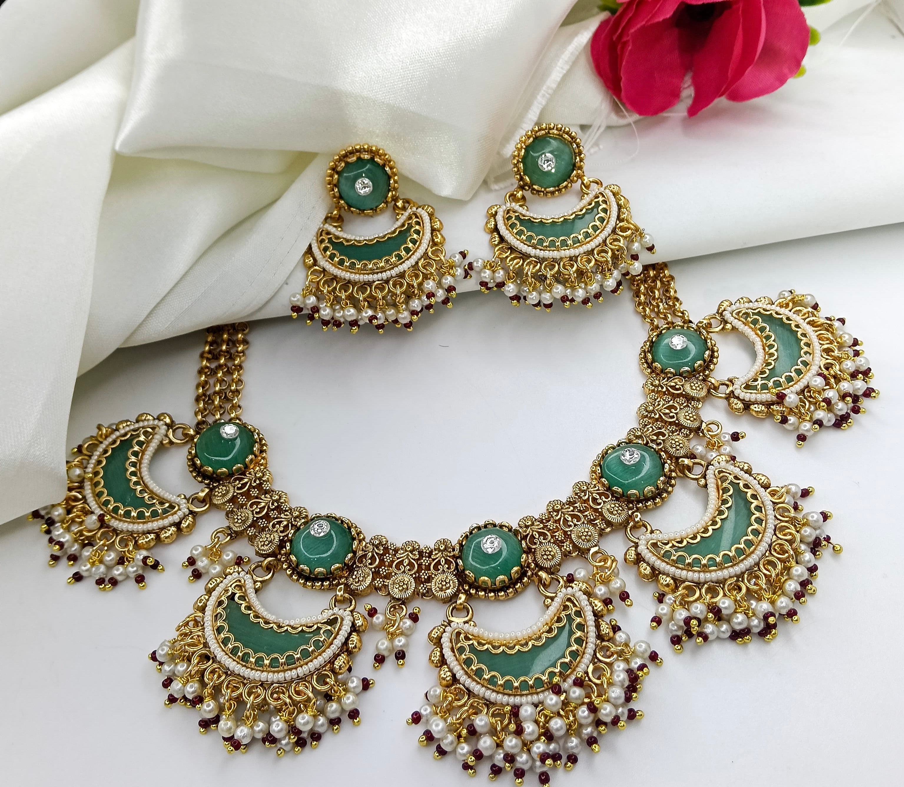 This is a green polki and emerald-style bridal necklace set with matching earrings.