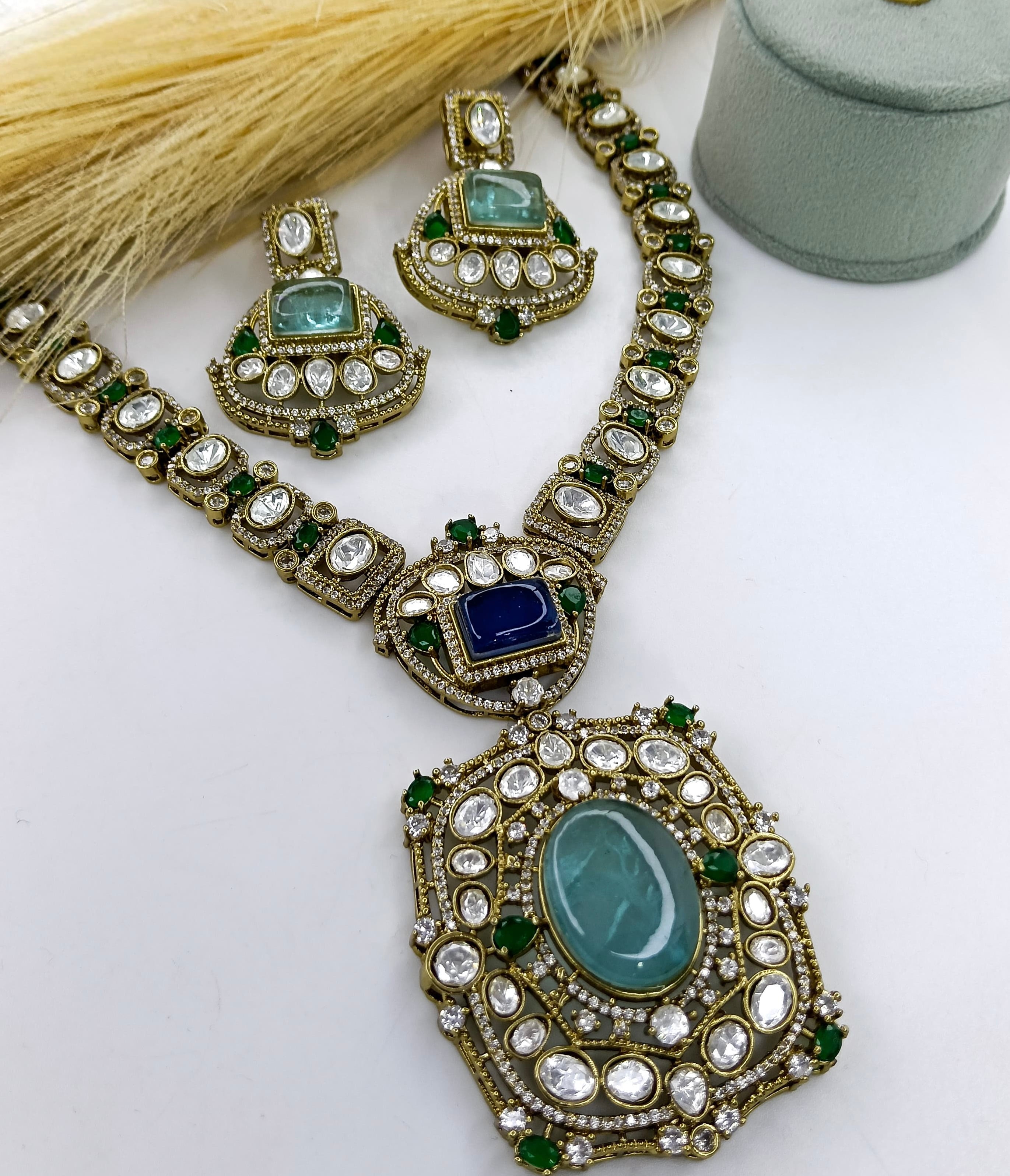 This is a Polki Kundan necklace set with green and blue stones.