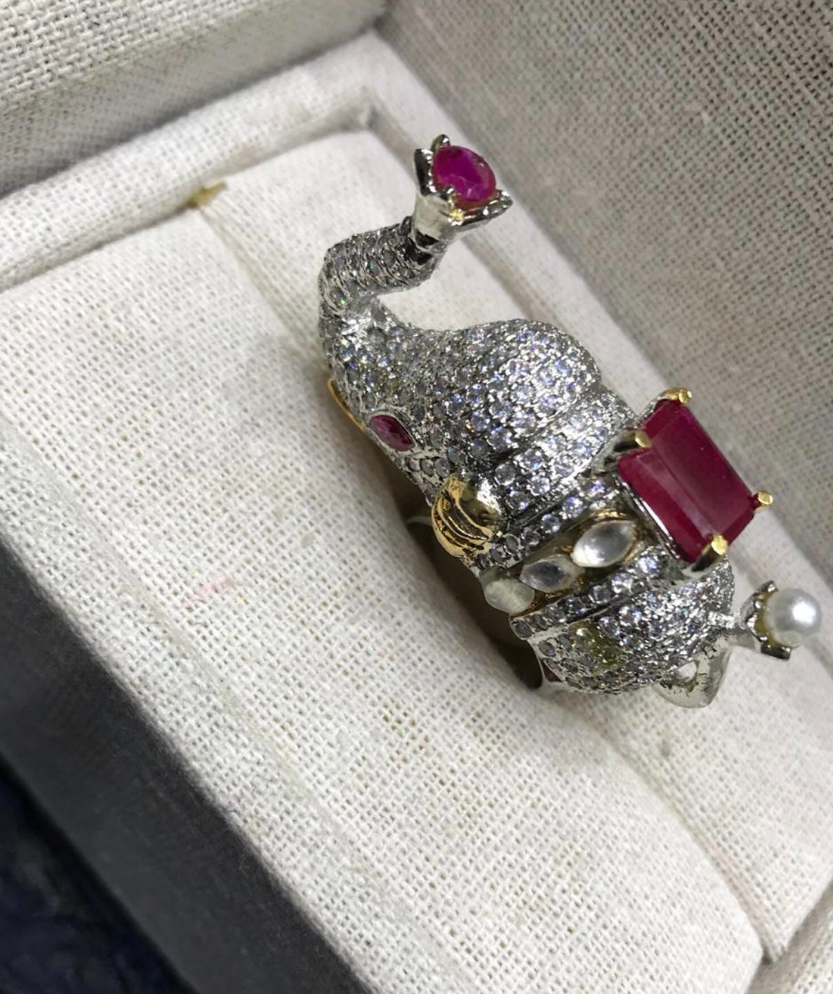 diamond designer elephant ring with a ruby gemstone.