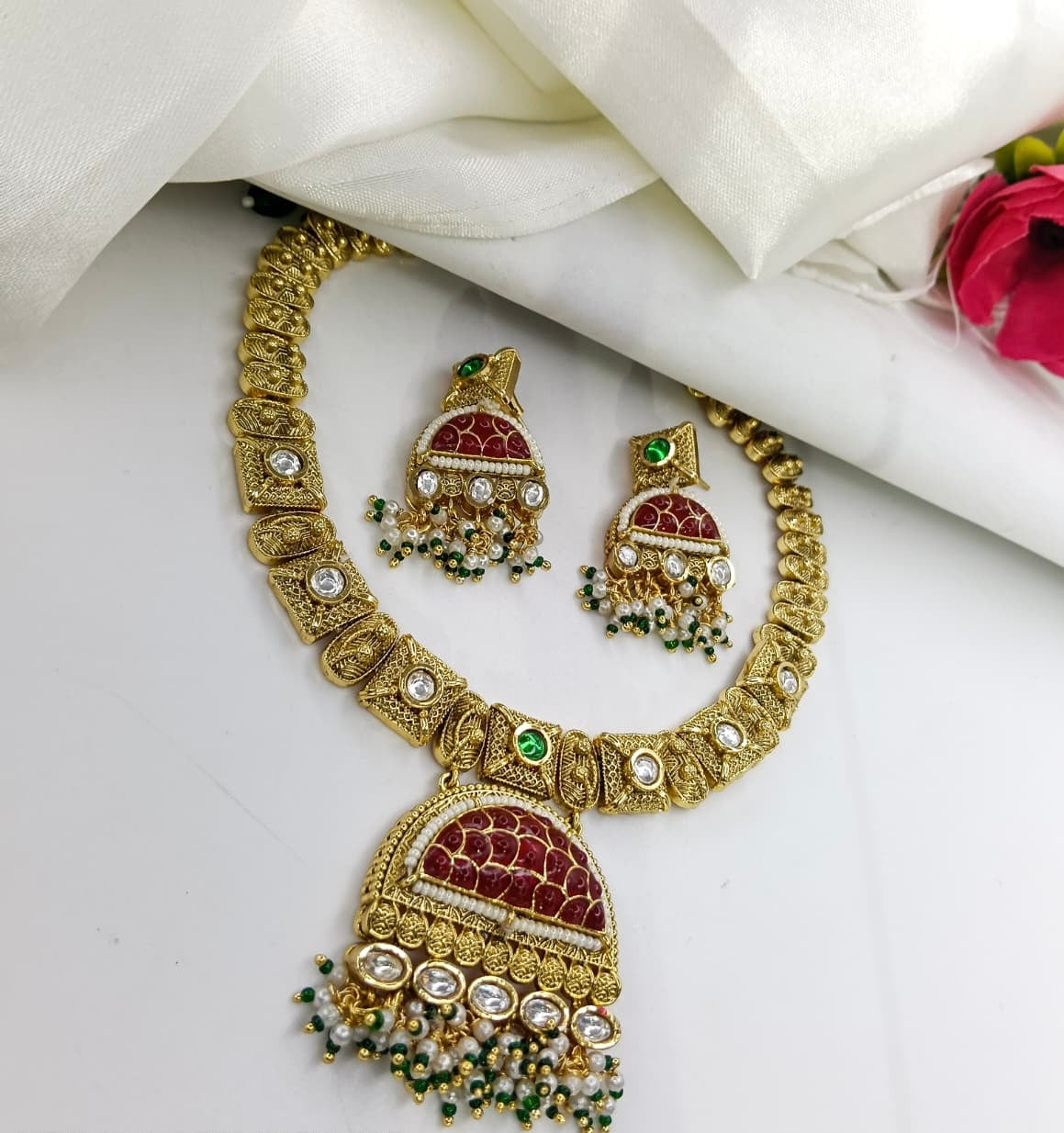 This is a Kundan necklace set with a red and green design.
