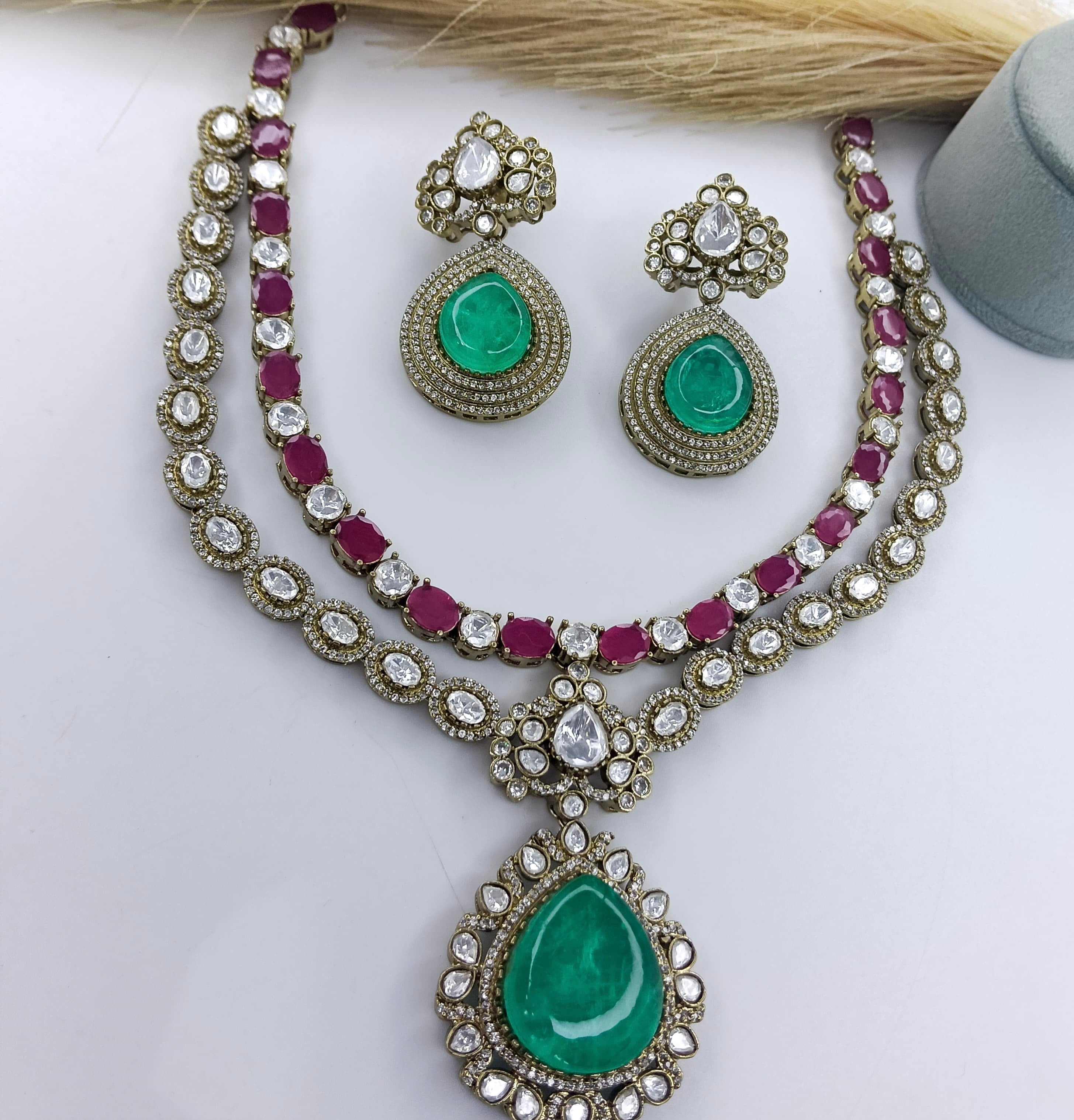 This is a Maharani Moissanite and Polki bridal semi-bridal set with emerald green stones.