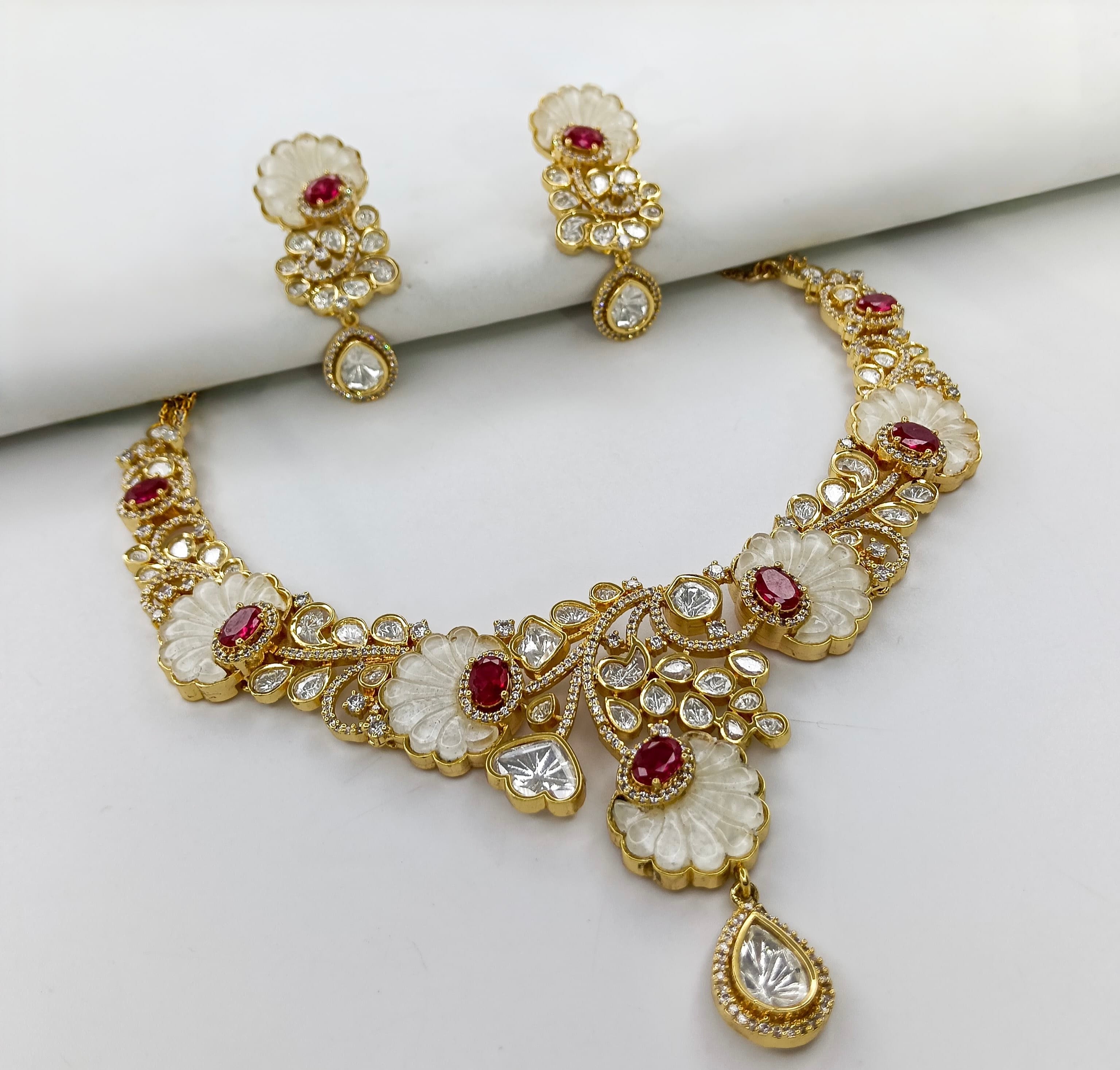 This is a gold-plated Kundan and Polki bridal necklace set with matching earrings.