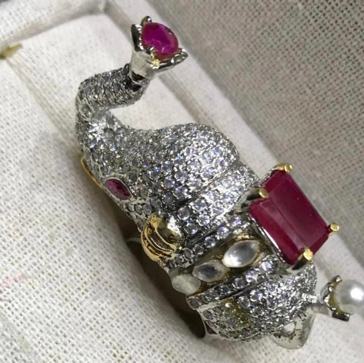 diamond designer elephant ring with a ruby gemstone.