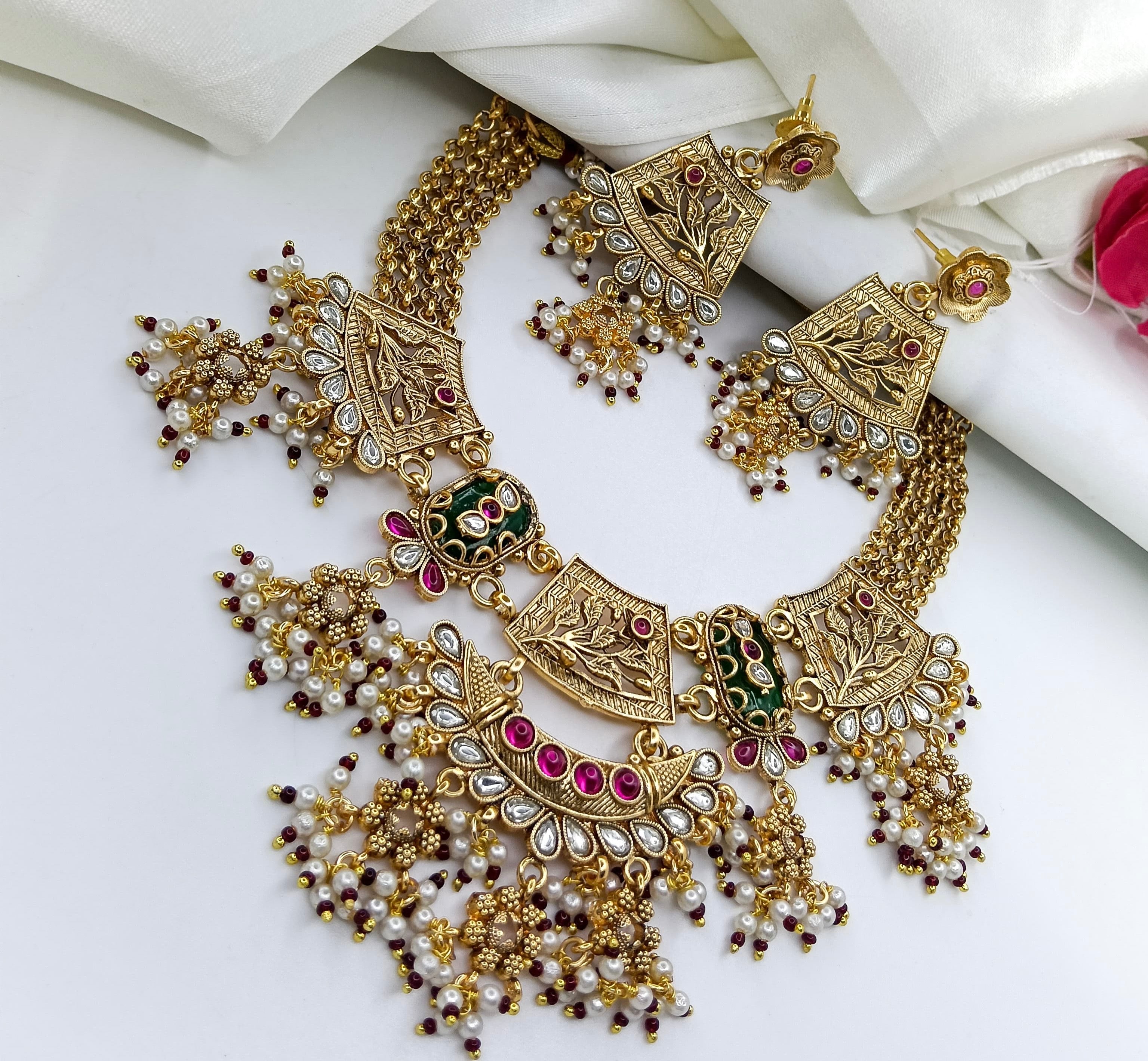 This is a Rajputi Kundan pearl and stone-studded necklace set with matching earrings.