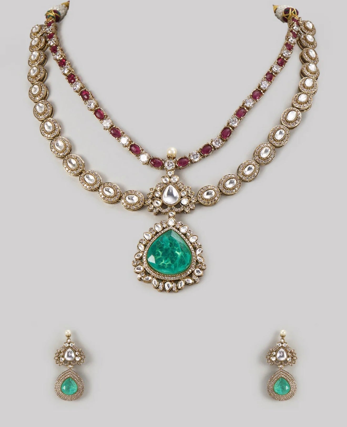 This is a Maharani Moissanite and Polki bridal semi-bridal set with emerald green stones.