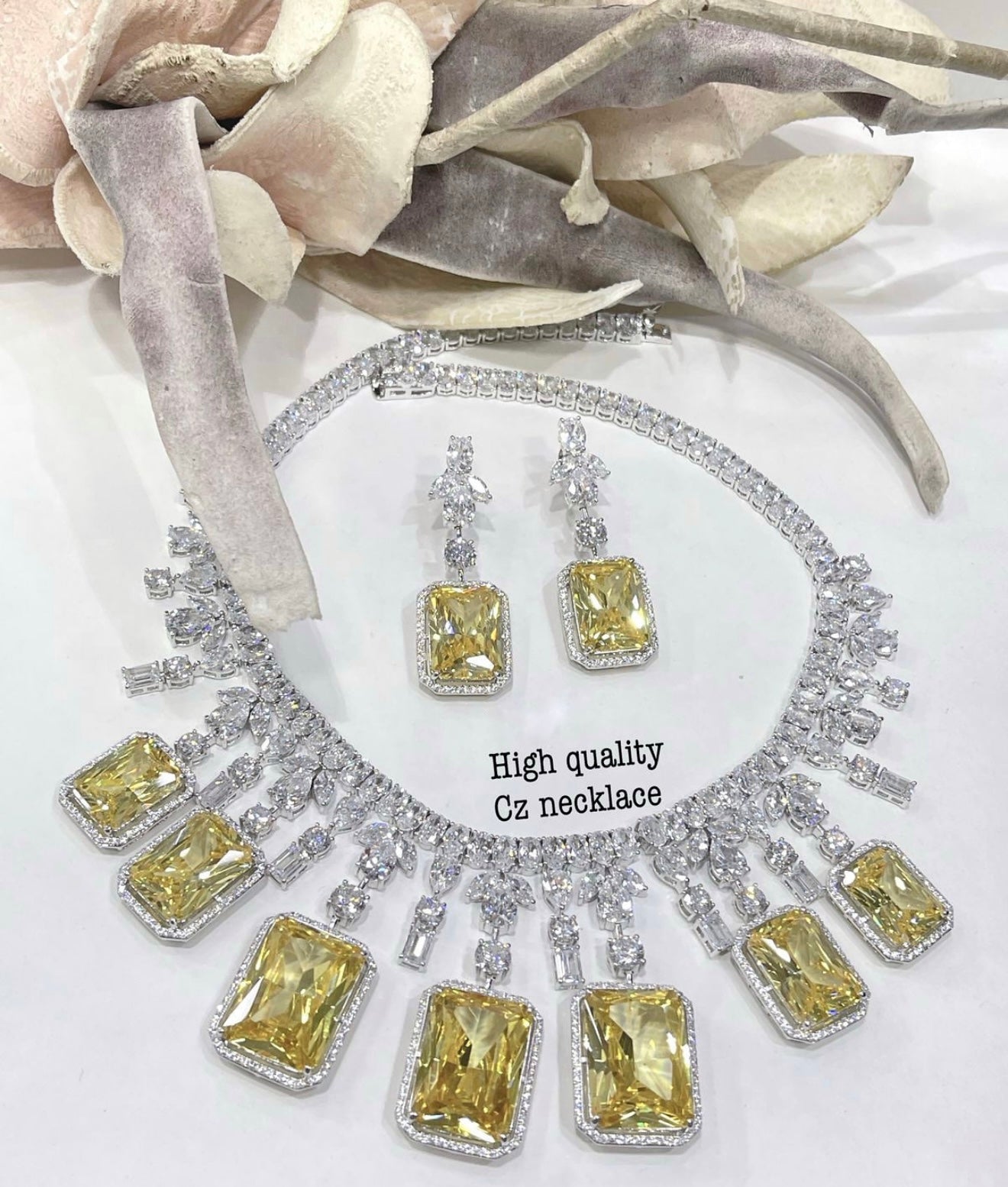 This is a yellow cubic zirconia necklace and earring set.