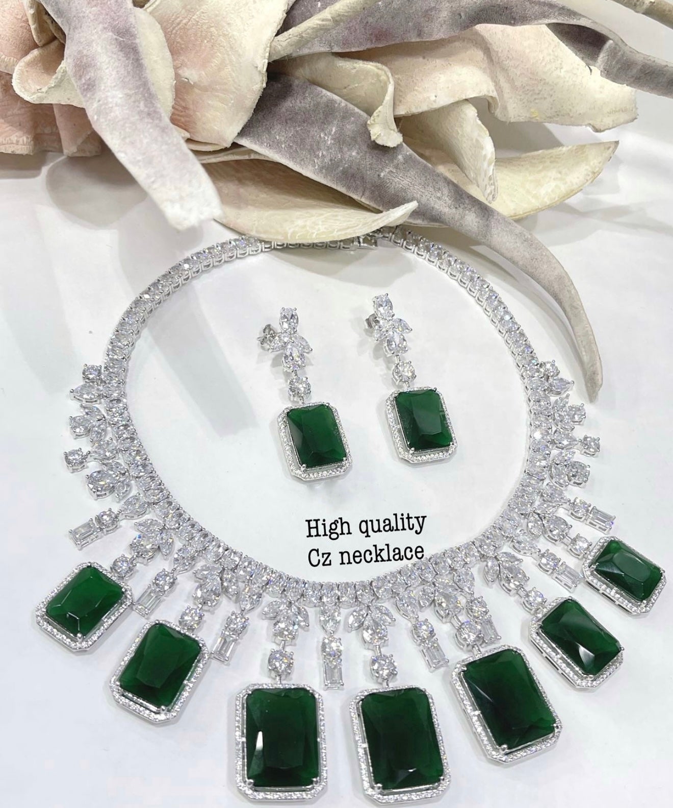 This is a Green cubic zirconia necklace and earring set.