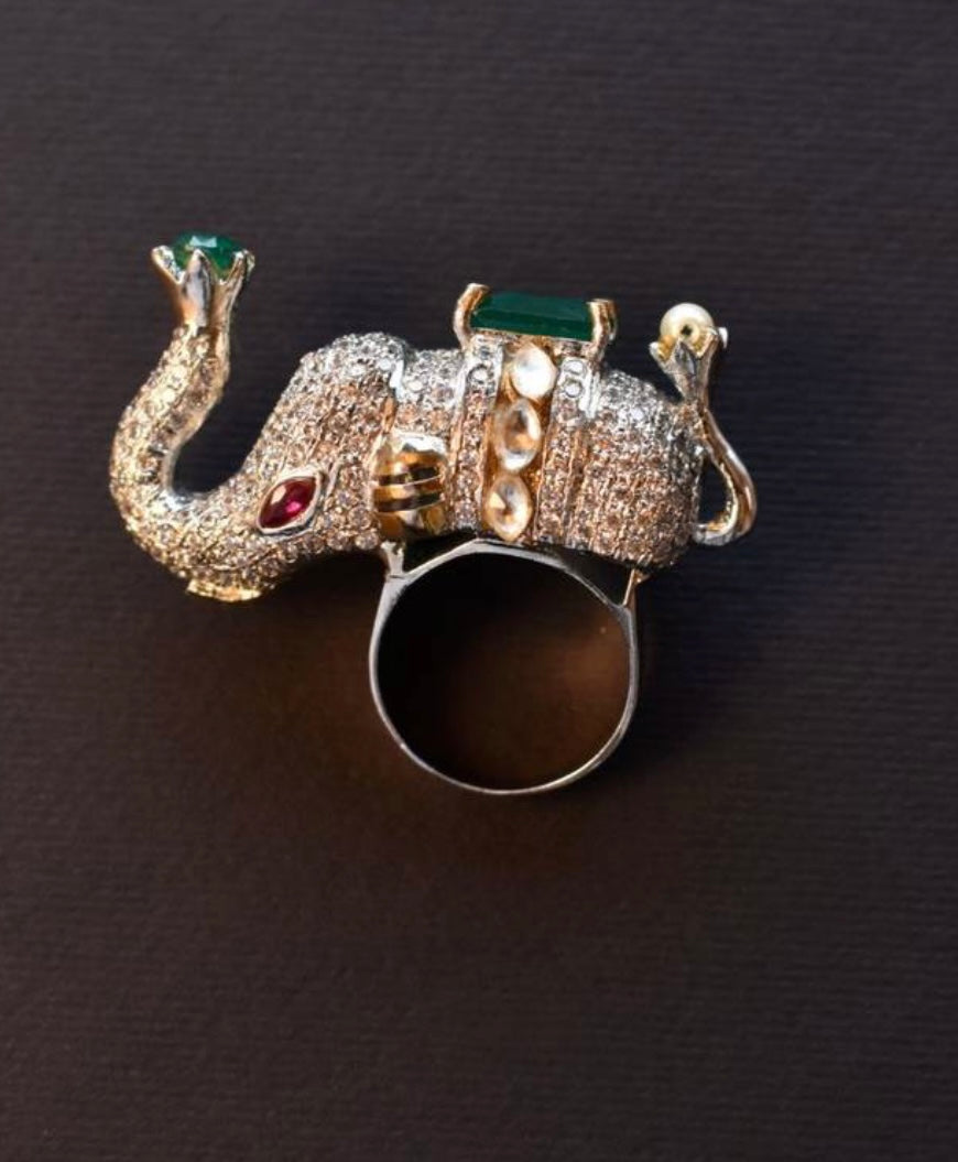 diamond designer elephant ring with a green gemstone.